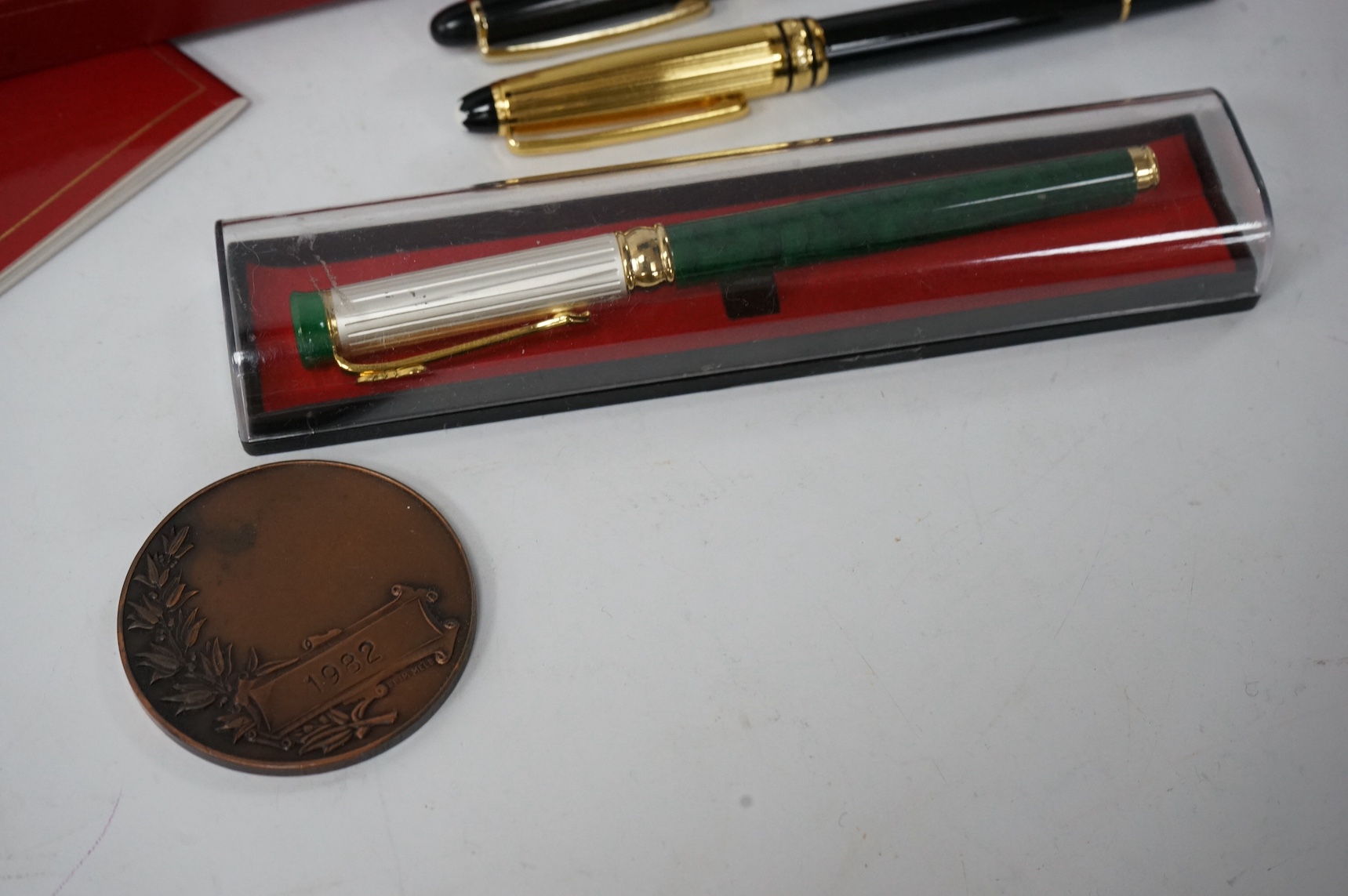 A collection of various pens and a H.N. Ansell medal. Condition - varies